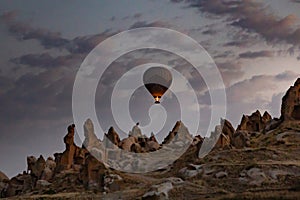 Cappadocia, Turkey - September 1, 2021 - Cappadocia Panoramic - Hot air balloon flying in early morning over rock landscape at