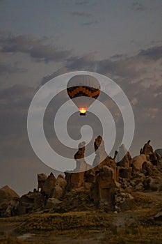 Cappadocia, Turkey - September 1, 2021 - Cappadocia Panoramic - Hot air balloon flying in early morning over rock landscape at