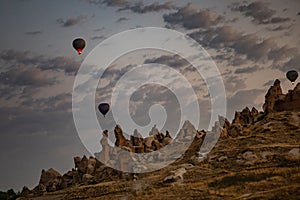 Cappadocia, Turkey - September 1, 2021 - Cappadocia Panoramic - Hot air balloon flying in early morning over rock landscape at