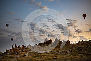 Cappadocia, Turkey - September 1, 2021 - Cappadocia Panoramic - Hot air balloon flying in early morning over rock landscape at