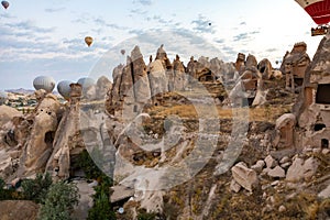 Cappadocia, Turkey - September 1, 2021 - Cappadocia Panoramic - Hot air balloon flying in early morning over rock landscape at