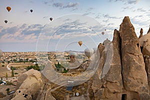 Cappadocia, Turkey - September 1, 2021 - Cappadocia Panoramic - Hot air balloon flying in early morning over rock landscape at