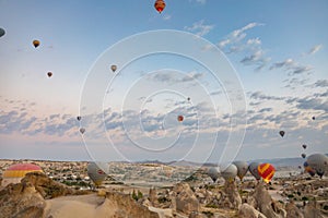 Cappadocia, Turkey - September 1, 2021 - Cappadocia Panoramic - Hot air balloon flying in early morning over rock landscape at