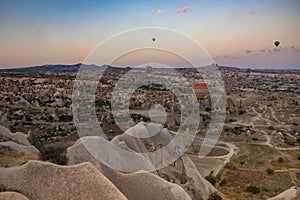 Cappadocia, Turkey - September 1, 2021 - Cappadocia Panoramic - Hot air balloon flying in early morning over rock landscape at