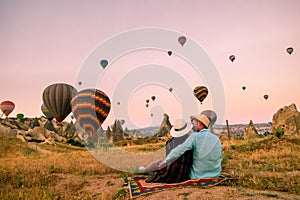 Cappadocia Turkey during sunrise, couple mid age men and woman on vacation in the hills of Goreme Capadocia Turkey, men photo