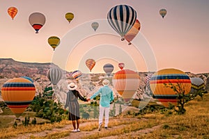 Cappadocia Turkey during sunrise, couple mid age men and woman on vacation in the hills of Goreme Capadocia Turkey, men