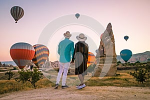 Cappadocia Turkey during sunrise, couple mid age men and woman on vacation in the hills of Goreme Capadocia Turkey, men