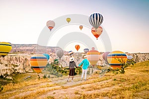 Cappadocia Turkey during sunrise, couple mid age men and woman on vacation in the hills of Goreme Capadocia Turkey, men