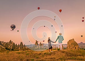 Cappadocia Turkey during sunrise, couple mid age men and woman on vacation in the hills of Goreme Capadocia Turkey, men