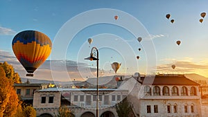 A Cappadocian magical morning with sunrise on the amazing background of a hundred flying balloons