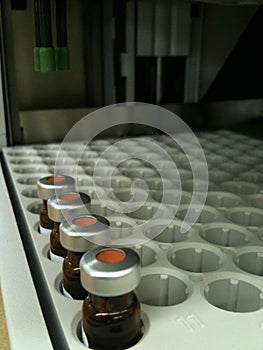 Capped sample vials on an HPLC analysis autosampler