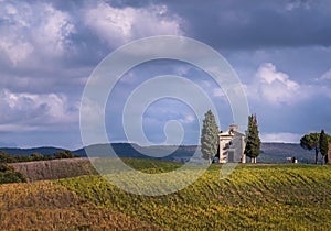 Cappella della Madonna di Vitaleta curch losted in endless Tuscany fields. Famous landmark place in Italy photo