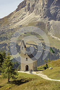 Cappella di San Maurizio, a lonely church at Magical Dolomite peaks of Pizes da Cir, Passo Gardena at blue sky and sunny day,