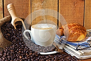 Cappuccino, brioches and newspaper with background photo