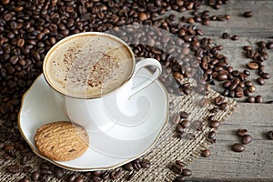 Cappuccino and coffee beans