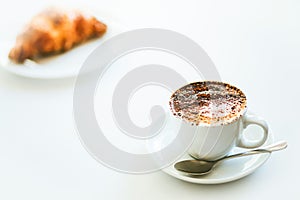 Cappuccino coffee and croissant isolated on white background