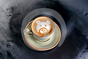 Cappuccino coffee in a cup with a bear