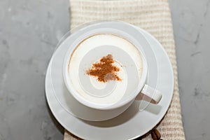 cappuccino coffee cup with cinnamon pattern, christmas drink,on concrete background