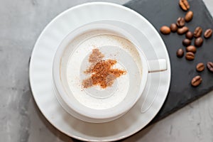 cappuccino coffee cup with cinnamon pattern, christmas drink,on concrete background