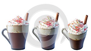 Cappuccino coffee in a glass mug with whipped cream, decorated with red, purple, pastry balls. Cinnamon roll in cream.