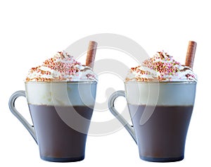 Cappuccino coffee in a glass mug with whipped cream, decorated with red, purple, pastry balls. Cinnamon roll in cream.