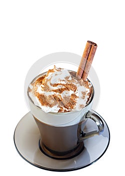 Cappuccino coffee, with whipped cream and ground cinnamon in a glass mug, on a saucer. Cinnamon stick. Isolate on a white backgrou