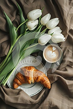 Cappuccino and croissant breakfast with white tulips on a table., Generated AI