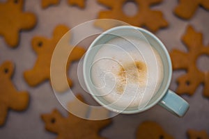 Cappuccino cup and home-made gingerbread in the background