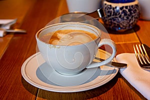 cappuccino cup on the wooden table background