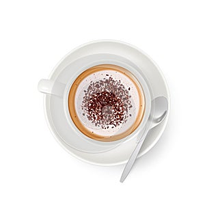 Cappuccino with froth, decorated with grated chocolate, in white cup and saucer