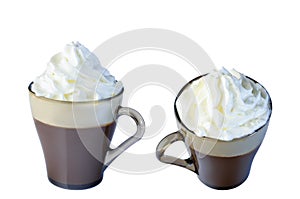 Cappuccino in a glass mug with whipped cream. Isolate on a white background.