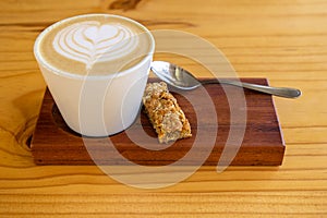 cappuccino with health buscuit on wood photo