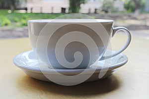 Cappuccino or latte with frothy foam, blue coffee cup top view closeup isolated on white background. Cafe and bar, barista art