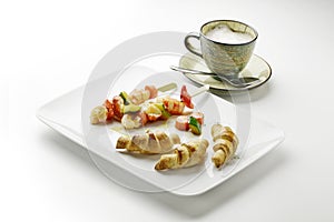 Cappuccino of potato croissants and shrimp skewers and vegetable