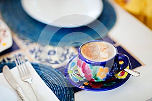 Cappuccino served in colorful cup