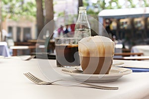 Cappuccino on table in Mediterranean cafe with blurred background