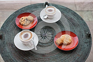 Cappuccino in white circles with cookies.