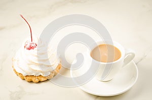 Cappuccino white cup and fresh cake with cherry/cappuccino white cup and fresh cake with cherry on a white marble background.