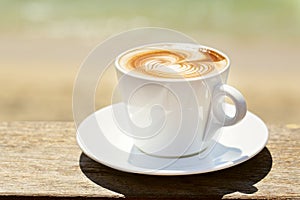 Cappuchino or latte coffe in a white cup with