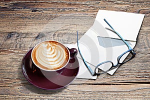 Cappucino with heart shape, letters, enveloppe and eyeglasses