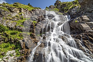 Capra Waterfall located on famous road Transfagarasan in Romania photo