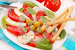 Caprese salad with grissini photo