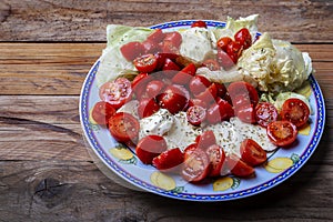 Caprese Salad.Mediterranean. Mozzarella cherry tomatoes basil and olive oil