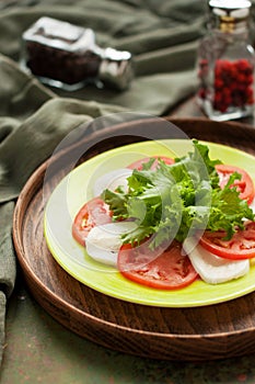 Caprese salad on rustic wooden tray