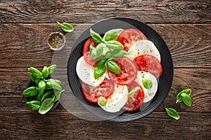 Caprese salad. Salad with mozzarella cheese, fresh tomatoes, basil leaves and olive oil. Italian cuisine