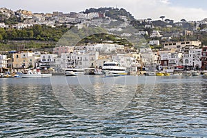 Capri island, Italy - April 12, 2017: Panorama of the seaport Marina Grande, view from the water on ships and colorful