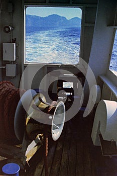 CAPRI, ITALY, 1965 - The anchor winch of a ferry greets the island of Capri, which moves away into the background