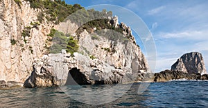 Caves in the cliffs on the island of Capri in the Bay of Naples, Italy. Photographed whilst on a boat trip around the island.