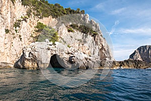 Caves in the cliffs on the island of Capri in the Bay of Naples, Italy. Photographed whilst on a boat trip around the island.