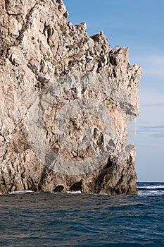 Caves in the cliffs on the island of Capri in the Bay of Naples, Italy. Photographed whilst on a boat trip around the island.